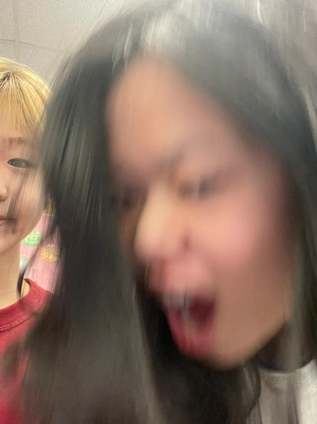 Selfie of myself and my friend, where I'm caught midway through moving my head towards the camera creating a blurred effect