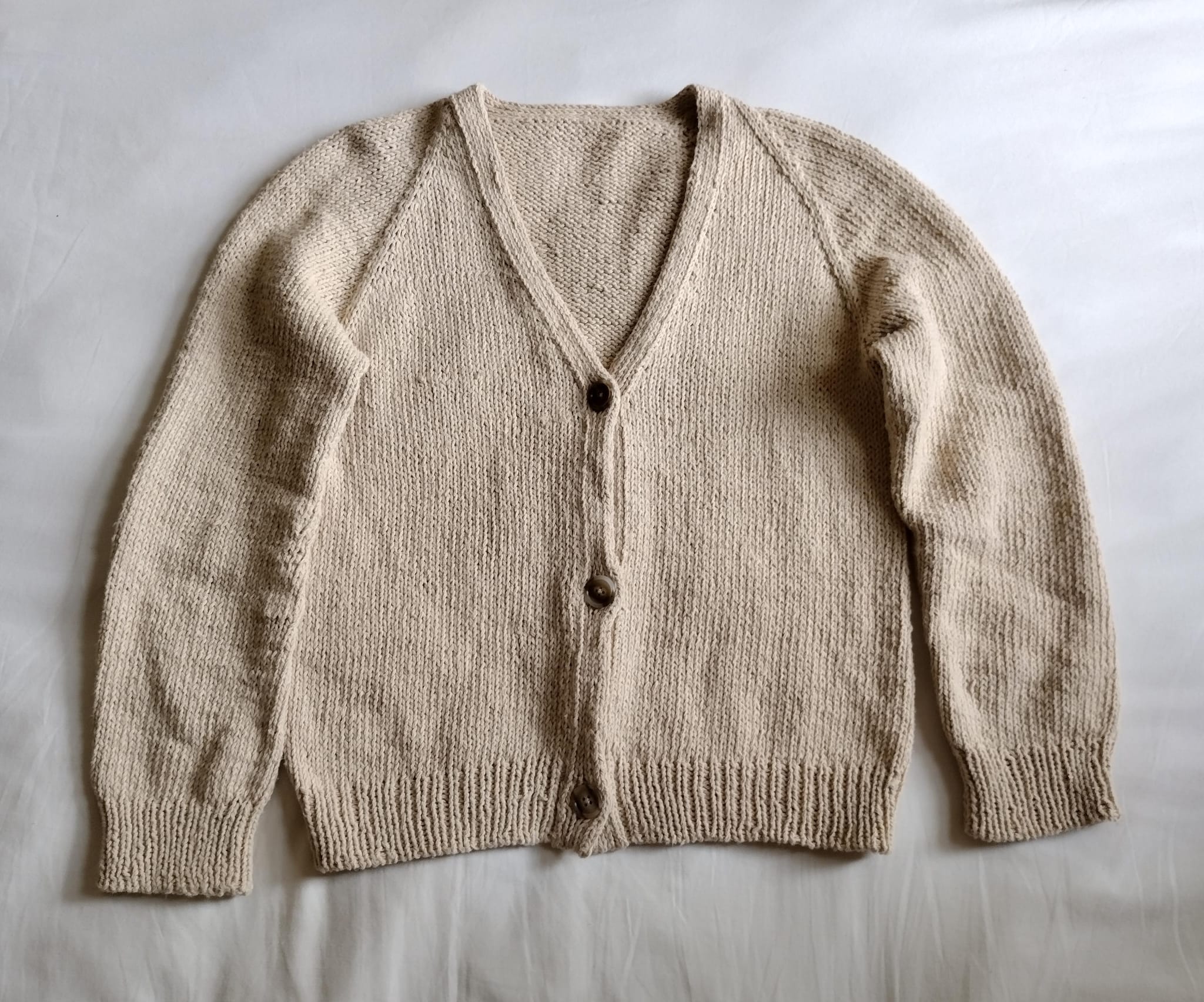 Image of a beige cardigan I knitted, with a white background.